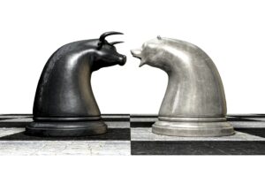 A black and white chess board with two silver horses facing each other.