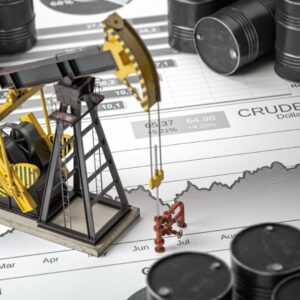 A miniature oil rig and some barrels on top of a map.