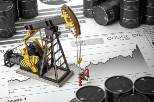 A miniature oil rig and some barrels on top of a map.